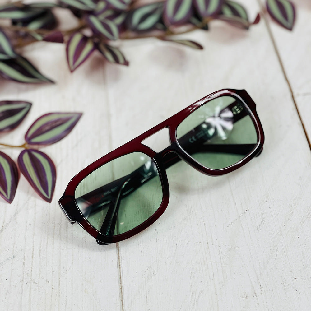 Dark red sunglasses with a greenish lens | Phil | JohNocera